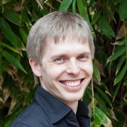 Man wearing black shirt in front of green background