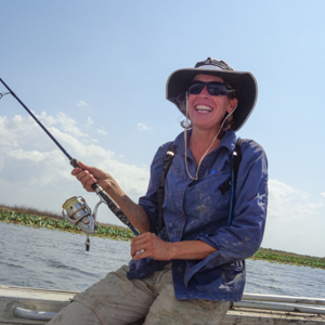 Woman in boat holding fishing rod